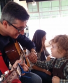 "Mr. Gabe" Hutter ’88 plays guitar for a young fan